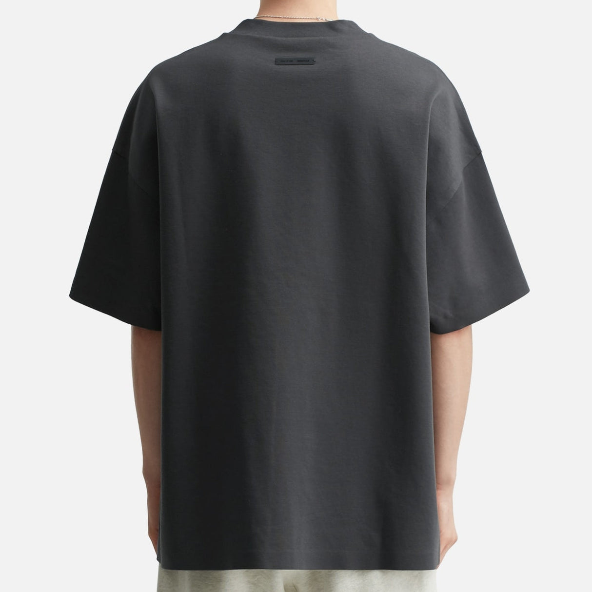 Fear of God Essentials Reflective Logo Ponte 90s Tee in Iron Dark Grey, featuring a reflective logo on a casual, fitted t-shirt.