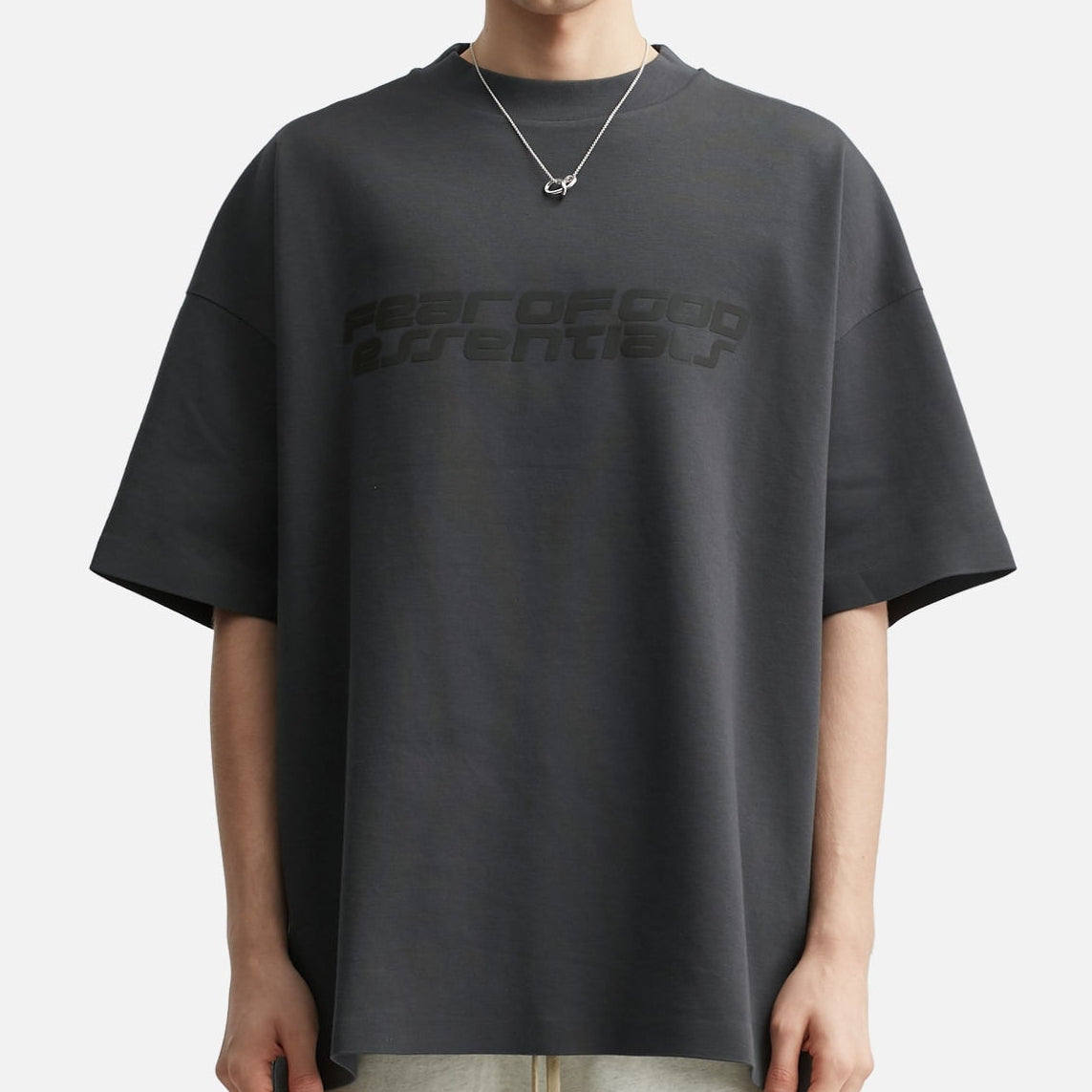 Fear of God Essentials Reflective Logo Ponte 90s Tee in iron dark grey, showcasing the soft fabric and reflective logo design.