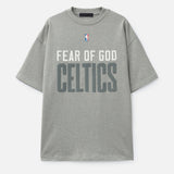 Fear of God Essentials NBA Celtics heavyweight tee in concrete, featuring team logo and 90s-inspired design on soft cotton fabric.