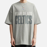 Fear of God Essentials NBA Celtics 90s heavyweight T-shirt in concrete color, featuring team logo and vintage design.