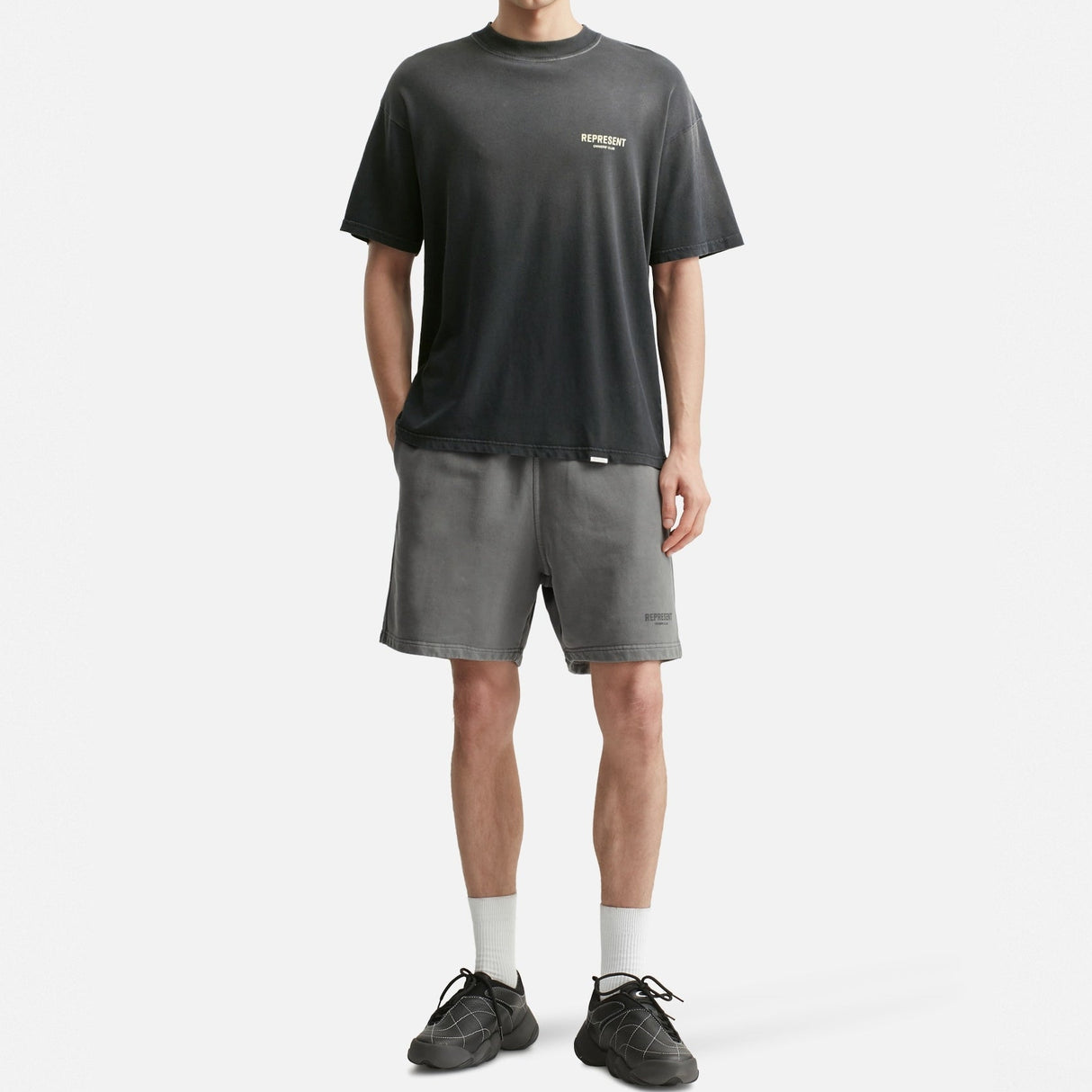 Black REPRESENT Owners Club Logo Tee featuring a prominent club logo on the front, casual crew neck design.