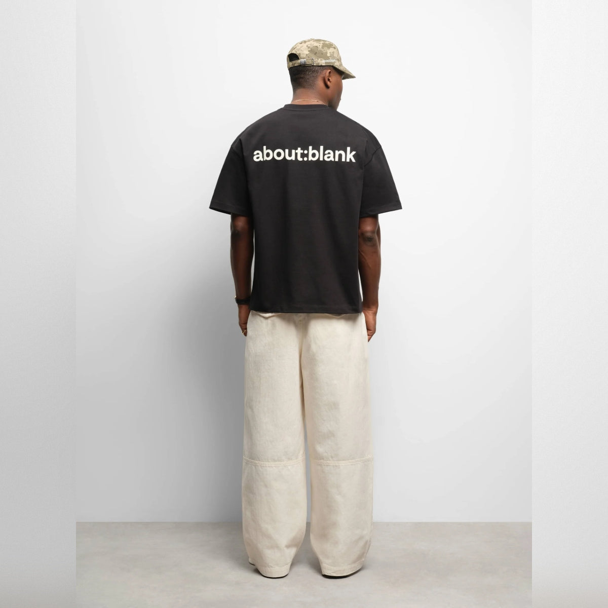 Black AboutBlank Reverse Blank Tee, casual black T-shirt with minimal design, made by ABOUT:BLANK, shown in a square image.