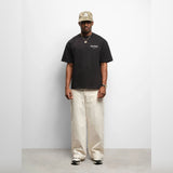 Black AboutBlank Reverse Blank Tee shirt displayed flat, showcasing its simple, classic design and smooth fabric texture.
