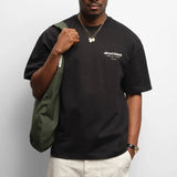 Black AboutBlank Reverse Blank T-shirt, casual apparel with minimal design, shown flat on a white background.