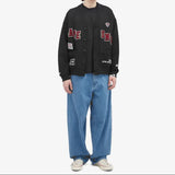 AAPE by BATHING APE UNVS cardigan featuring a stylish knit design in neutral tones, displayed on a flat lay.