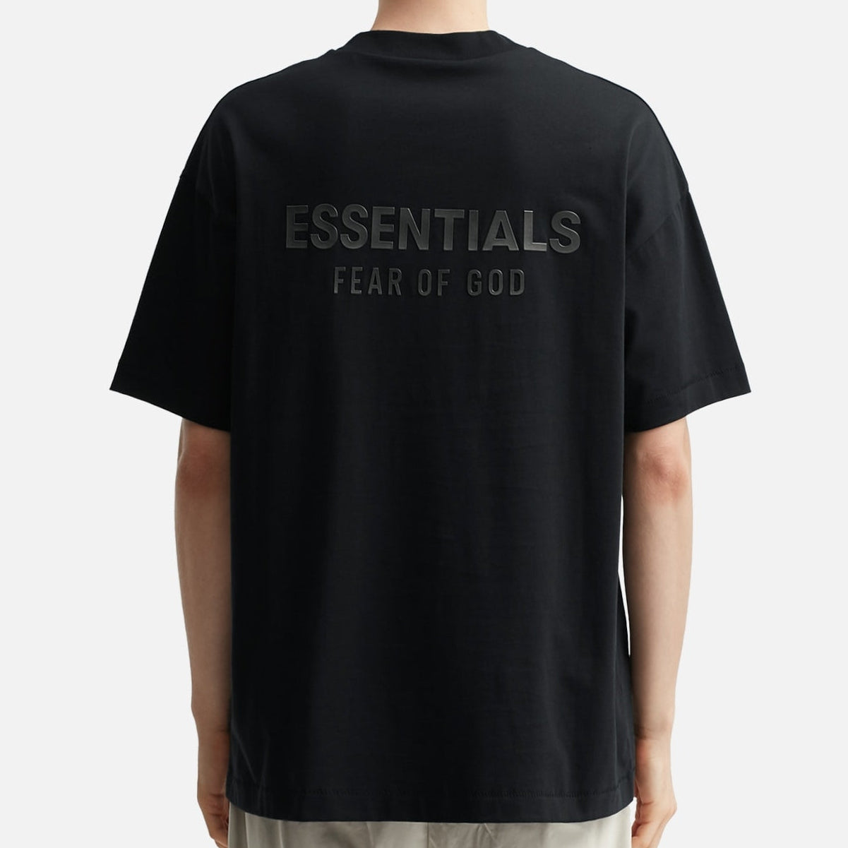Fear of God Essentials metallic logo classic black T-shirt, front view showing logo design and soft cotton fabric.