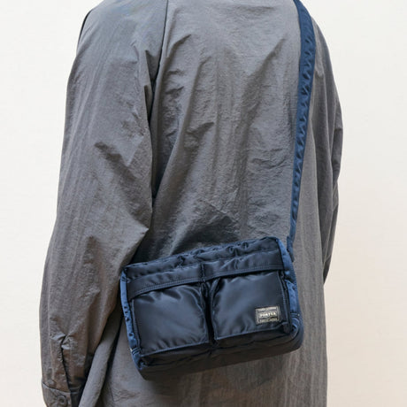 Porter Yoshida Japan Tanker Zip Sling Bag in navy with adjustable strap and zipper closure, displayed against a plain background.