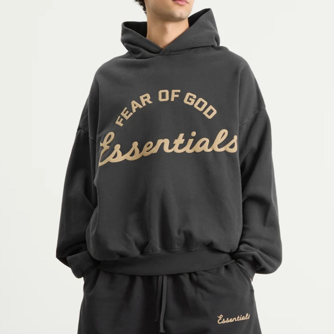 Fear of God Essentials Training 90s Heavyweight Hoodie in iron gray, front view showing relaxed fit and branded logo.