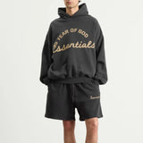 Fear of God Essentials Training 90s Heavyweight Hoodie in iron gray, showing the front view with logo details and soft fabric texture.