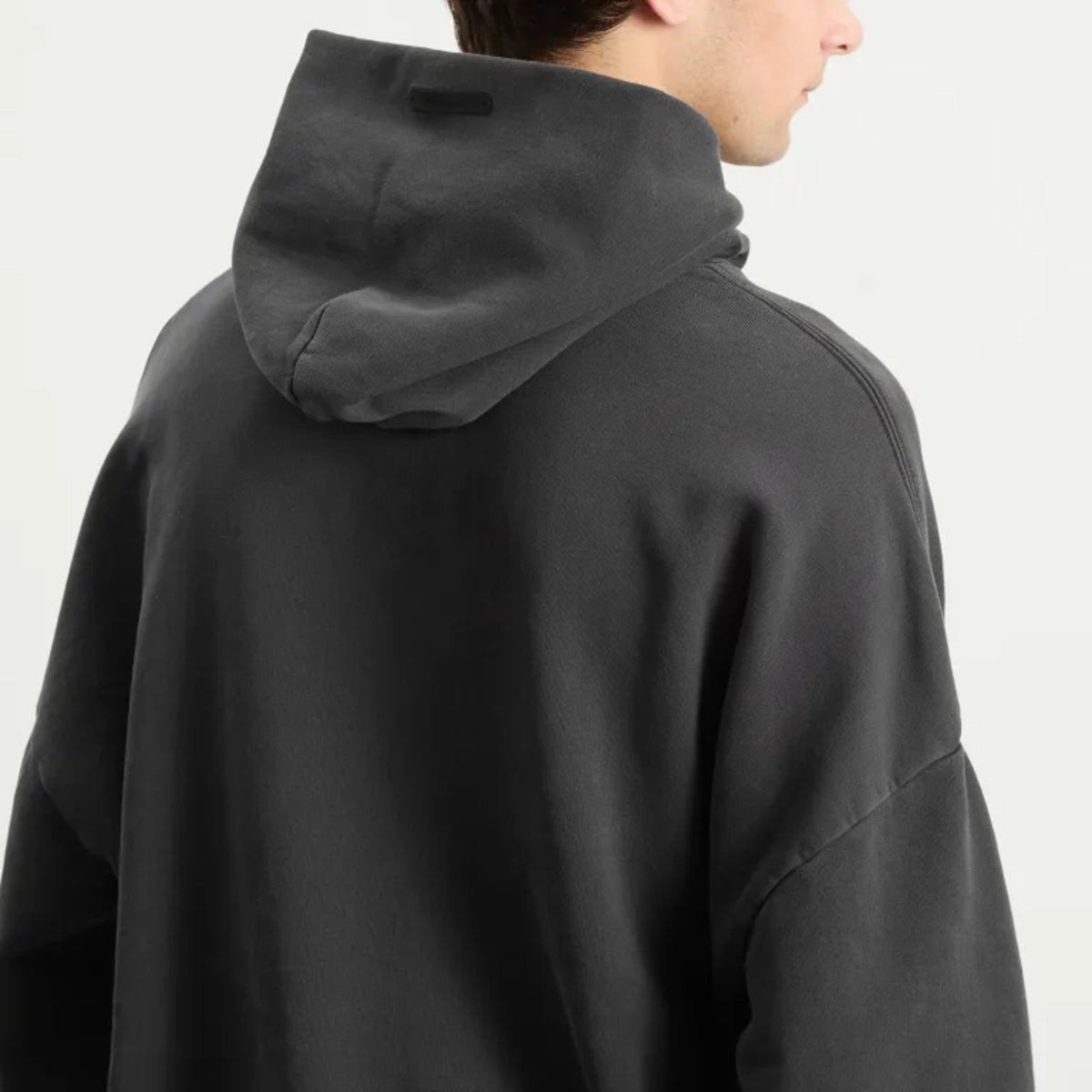 Fear of God Essentials Training 90s Heavyweight Hoodie in iron gray, showcasing the soft, chunky fabric and classic fit.