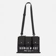 Black Human Made military shoulder bag with adjustable strap and multiple compartments, designed for versatile carrying.