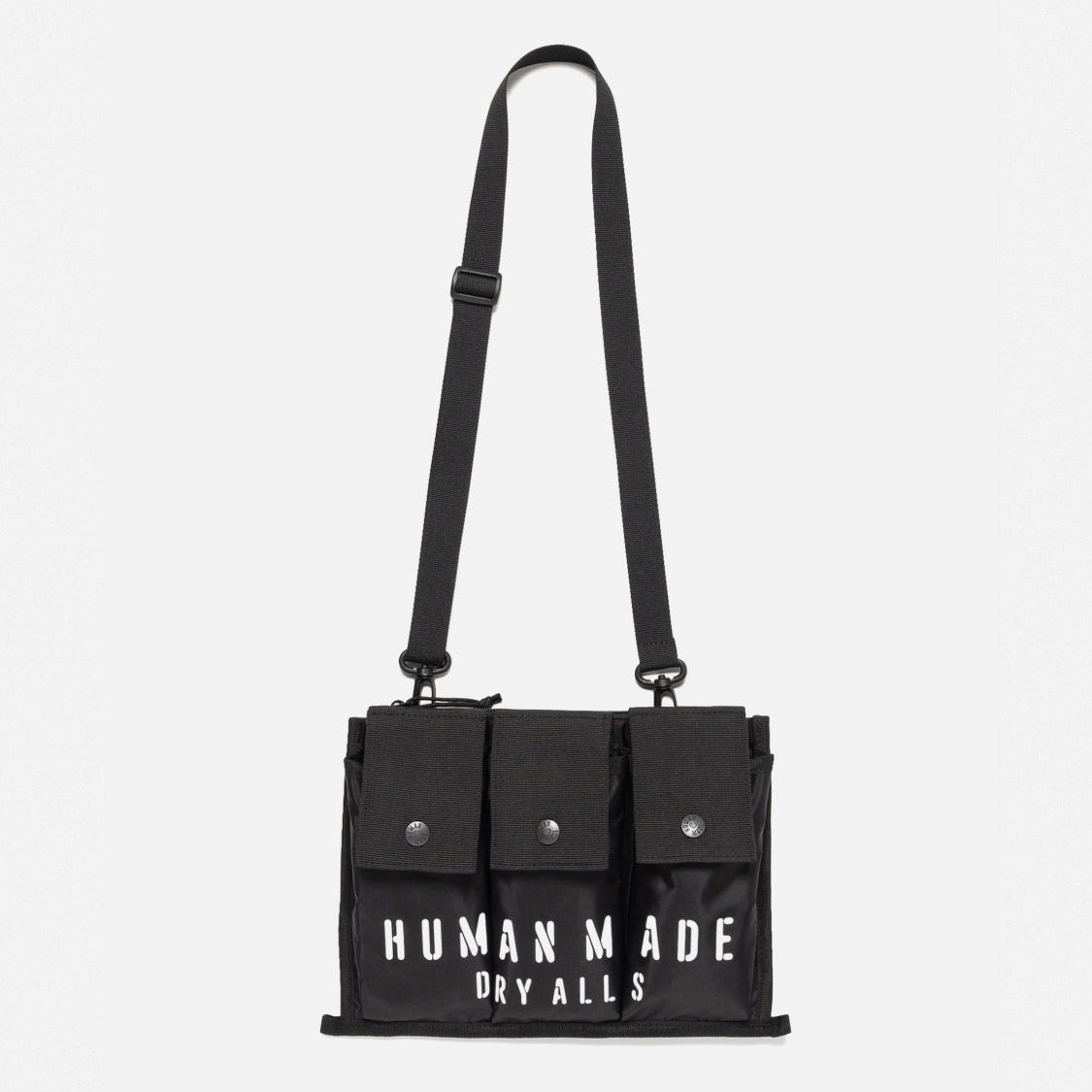 Black Human Made military shoulder bag with adjustable strap and multiple compartments, designed for versatile carrying.
