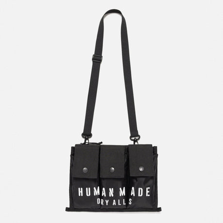 Black Human Made military shoulder bag with adjustable strap and multiple compartments, designed for versatile carrying.