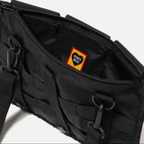 Human Made military shoulder bag in black, featuring adjustable strap and multiple compartments for everyday carry.