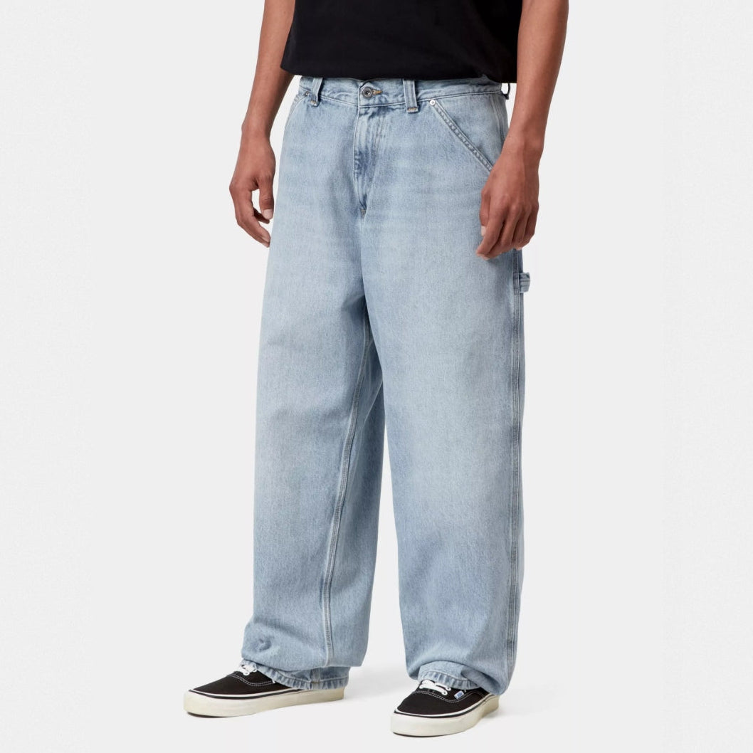Blue Carhartt WIP Belmont pants in worn bleached style, casual denim apparel with a relaxed fit and distressed finish.