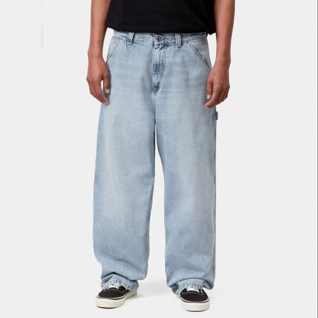 Carhartt WIP Belmont blue pants with a worn, bleached finish, casual men's apparel featuring a relaxed fit and durable fabric.