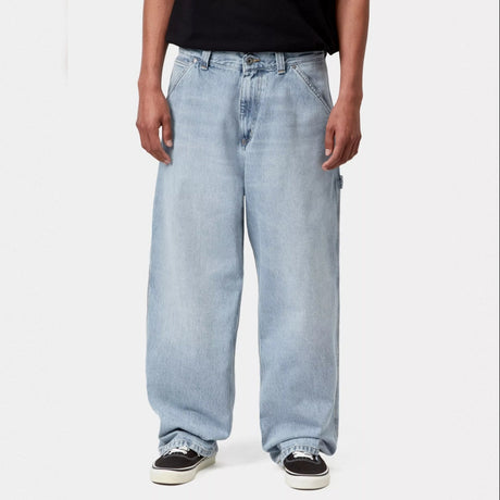 Carhartt WIP Belmont blue pants with a worn, bleached finish, casual men's apparel featuring a relaxed fit and durable fabric.