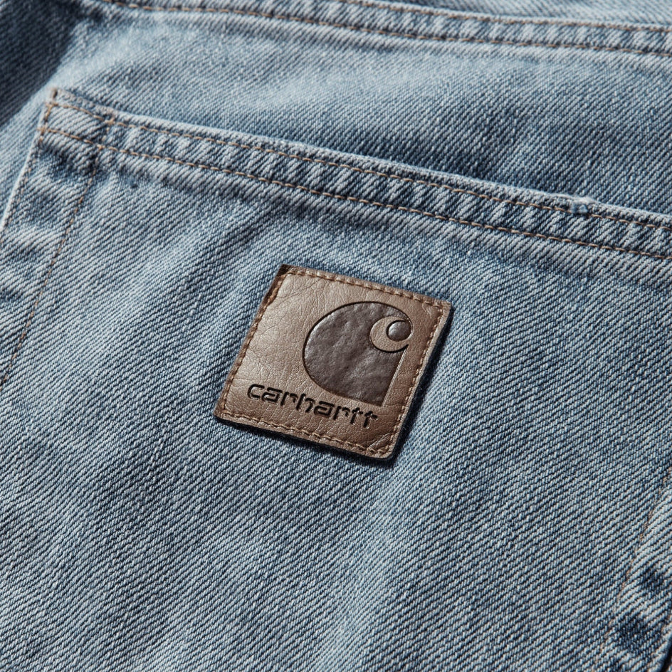 Carhartt WIP Aaron Pants in blue with a burst washed finish, casual men's apparel with a relaxed fit and durable fabric.