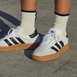 Adidas Originals Samba XLG sneakers in cloud white, core black, and gum color with classic low-top design and rubber sole.