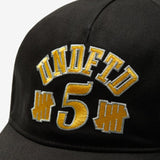 Black Undefeated 5 Logo snapback hat, stylish headwear with embroidered brand logo, adjustable brim, and flat top design.