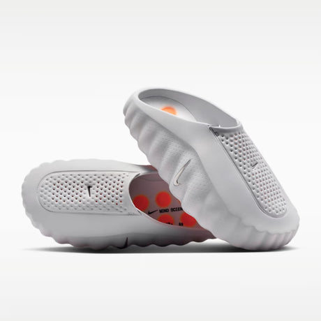 Nike Mind 001 mules shoes in black with Nike logo, featuring a sleek slip-on design and cushioned sole for comfort.